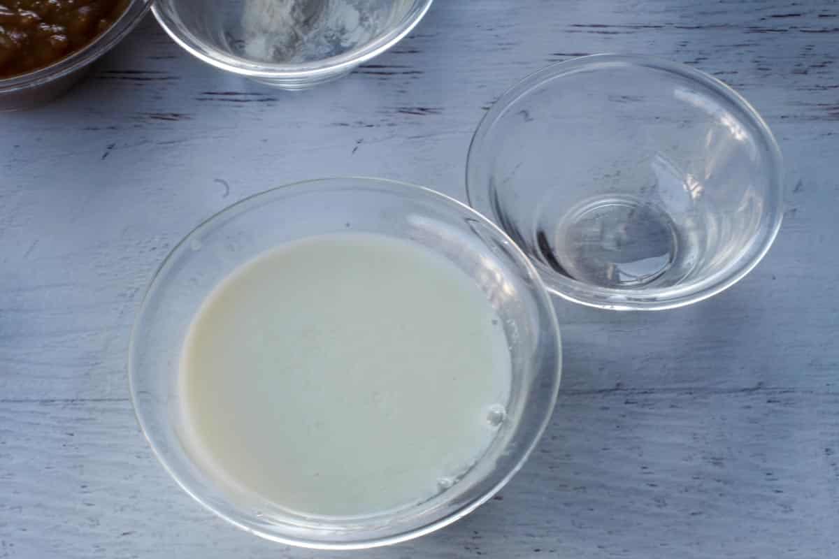 vinegar mixed into milk in glass bowl, with empty bowl beside it