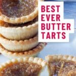 4 butter tarts stacked on a white plate, with a butter tart split in half in front of the stack