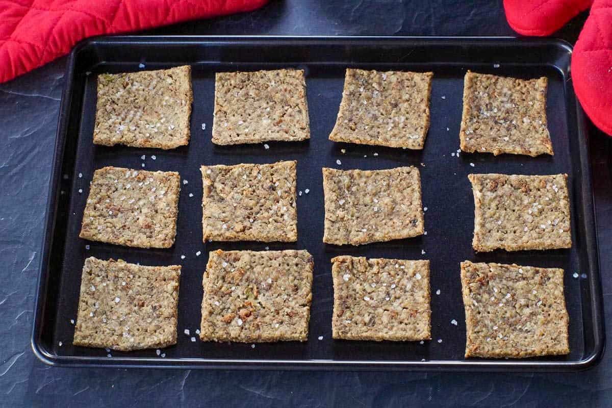 leftover stuffing crackers on a black baking sheet