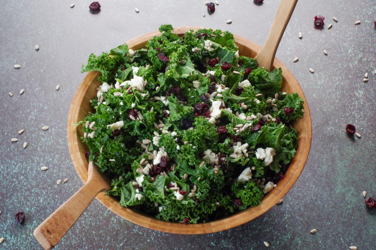 kale cranberry and feta salad with dressing, just prior to serving