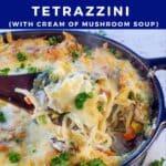 turkey tetrazzini being held up on a spoon over a casserole dish