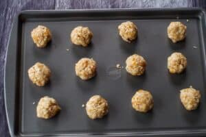 cookie dough rolled into balls on baking sheet