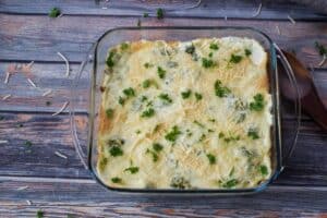 baked spinach artichoke casserole in square glass baking dish