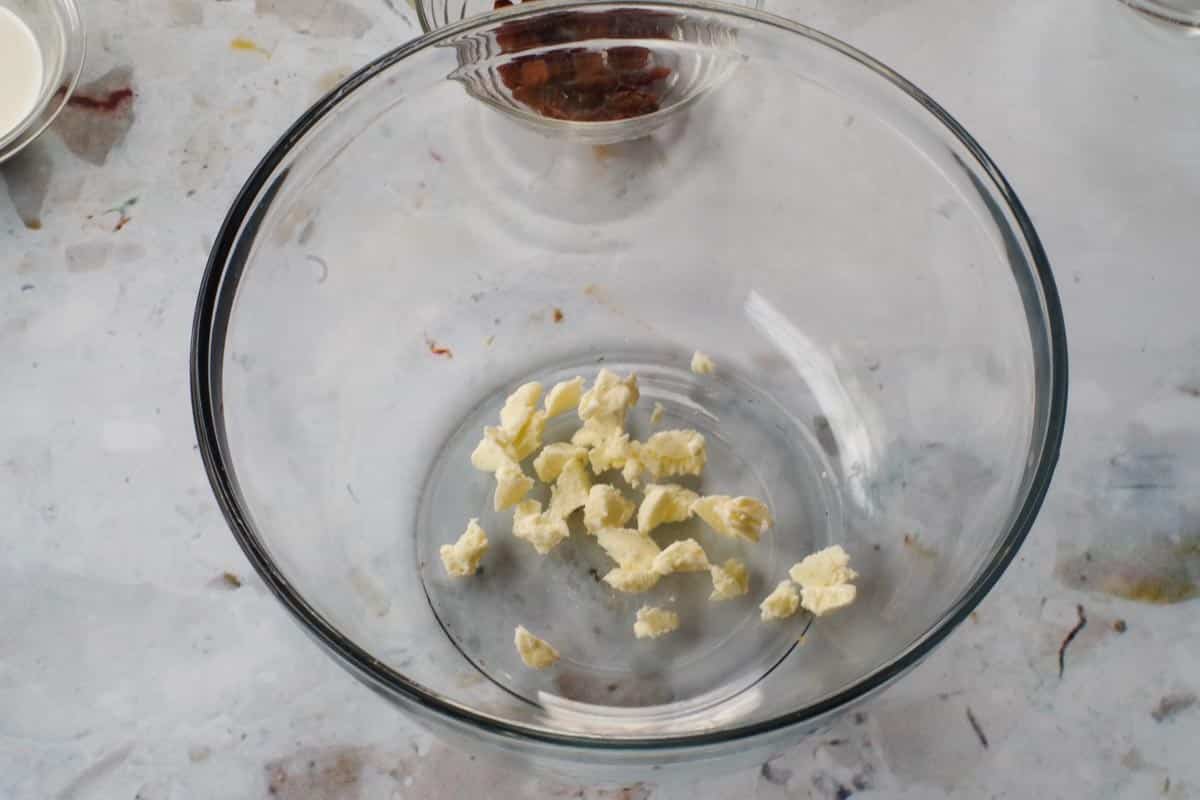 butter cut into small pieces in large glass bowl