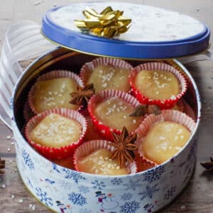 container with soft salted butter toffee in little red paper cups