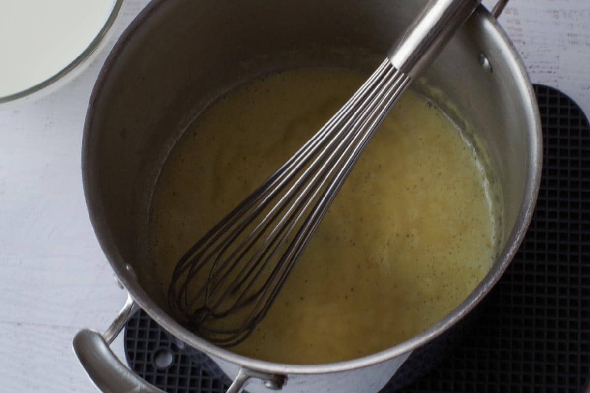 flour, bouillon, salt and pepper being whisked into butter