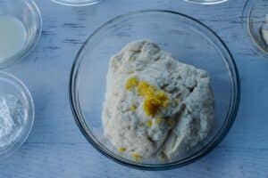 lemon zest and butter extract added to 2 ingredient dough in glass bowl