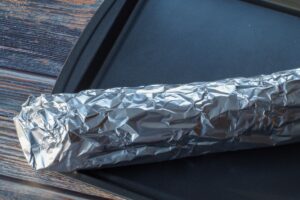 foil wrapped around ripped section of baguette