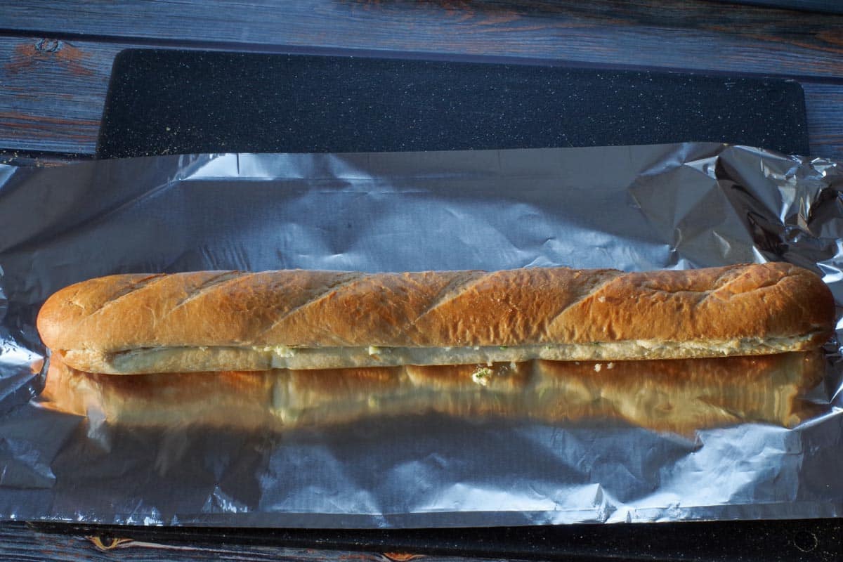 buttered baguette on a long piece of aluminum foil