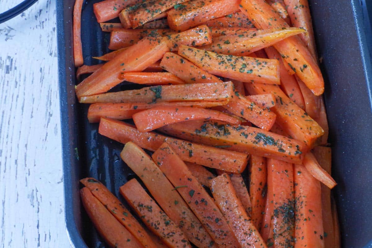 partially cooked carrot fries in air fryer drawer