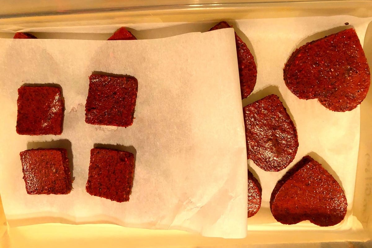 jello snacks cut into shapes between pieces of parchment
