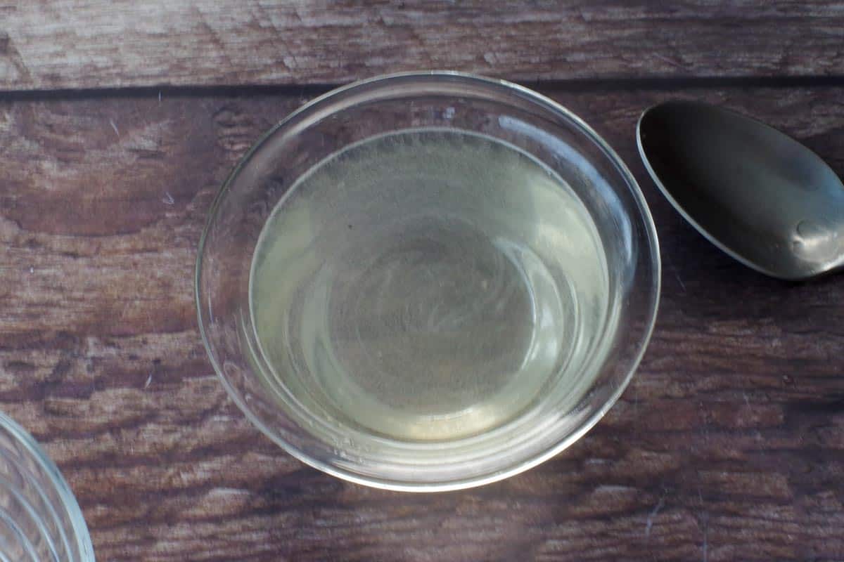 gelatin in a small glass bowl with other half of liquid added