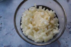 onions and butter in a glass microwave safe bowl
