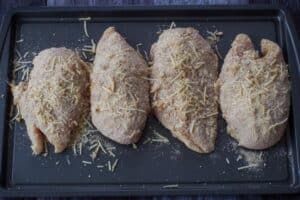 coated chicken on baking sheet