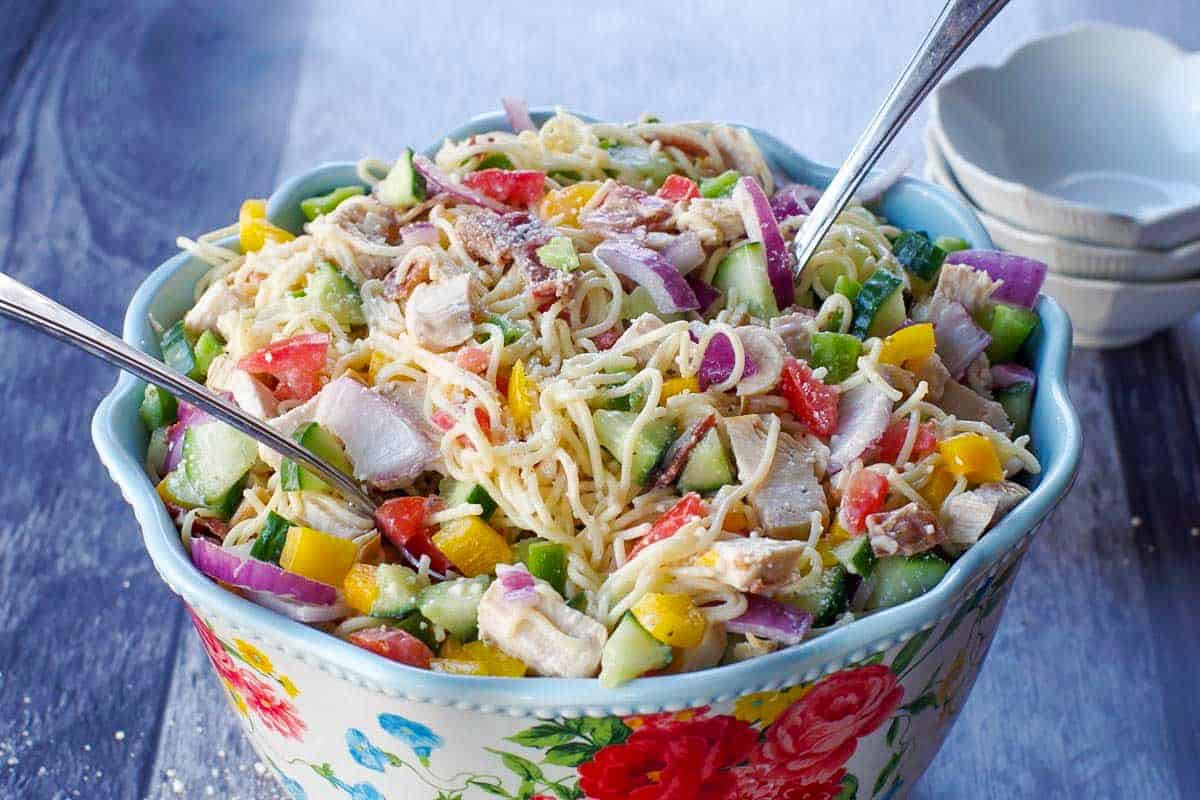 chicken bacon ranch pasta salad in a flowered bowl with a spoon