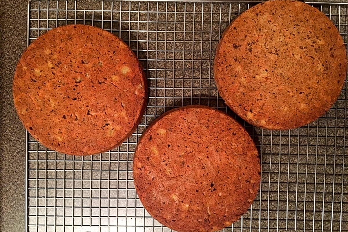 3 round carrot cakes on cooling rack