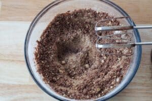 chocolate added to dry mixture in glass bowl
