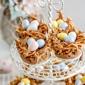 4 birds nest cookies on the top of a white wire display with more on the bottom