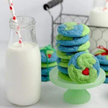 Earth Day cookies on a plater with a jug a milk beside the platter