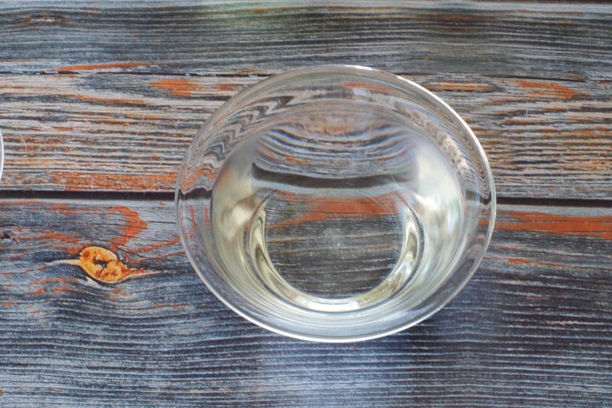 1 teaspoon sugar dissolving in 1 cup of water in a glass bowl