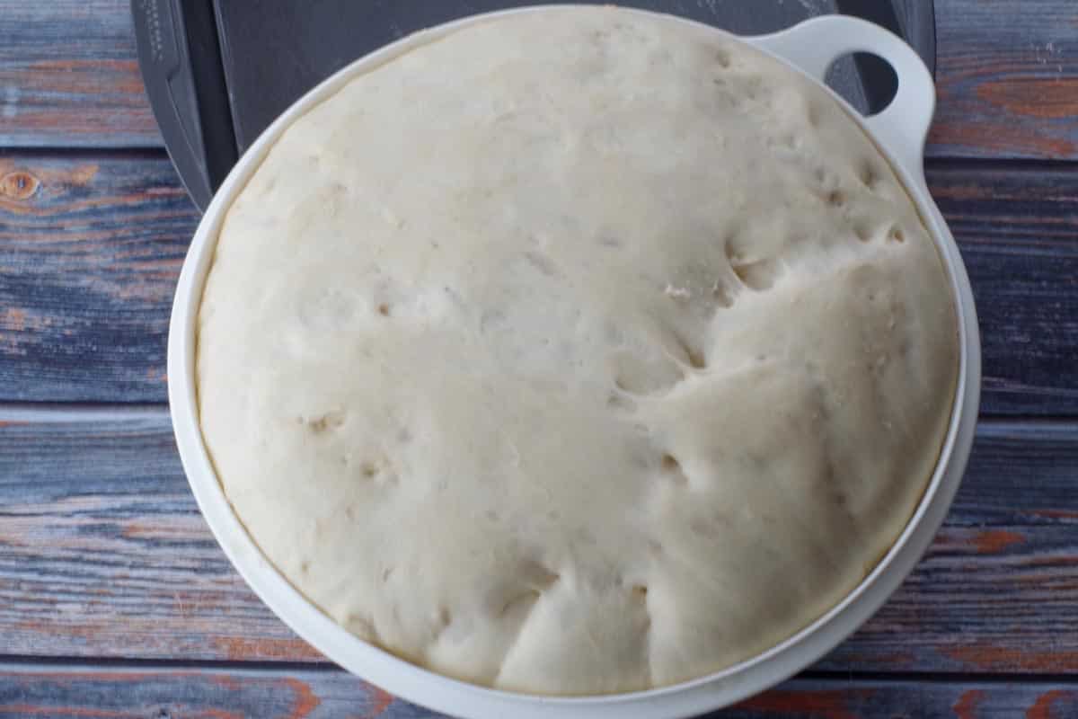 dough doubled in size in large white bowl