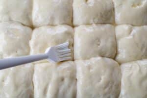 buns being brushed with butter