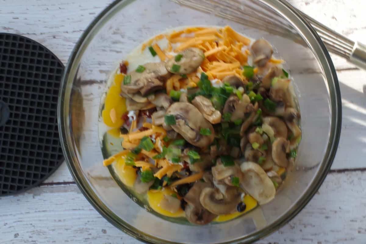 mushroom and onions added to other ingredients in large bowl
