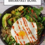 Avocado breakfast bowl in a black bowl with coffee and juice in the background and black linen napkin with fork, on right side