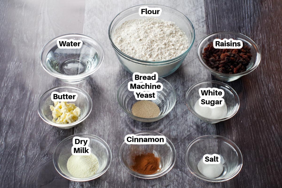 ingredients in cinnamon raisin bread machine recipe in glass bowls, labelled