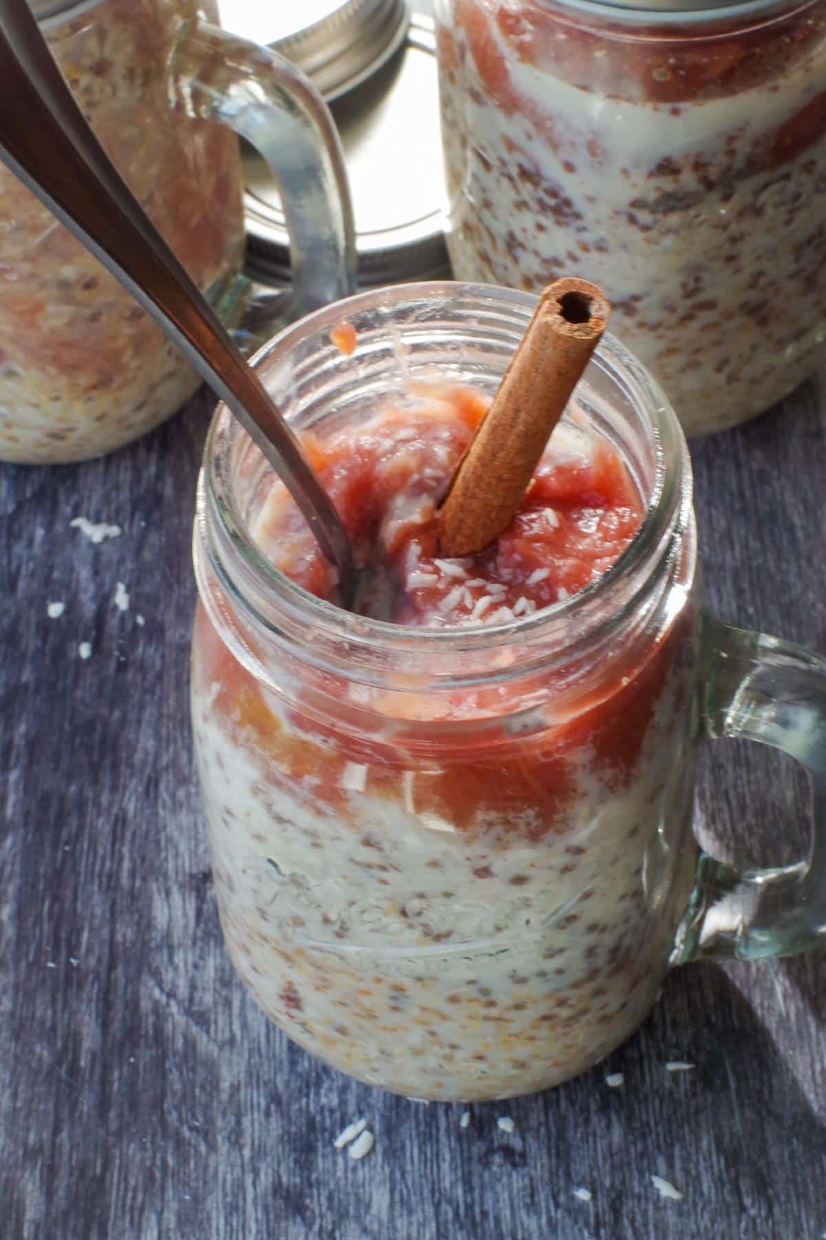 rhubarb overnight oats in a jar with 2 other jars in the background