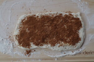 brown sugar/cinnamon mixture sprinkled on dough on cutting board