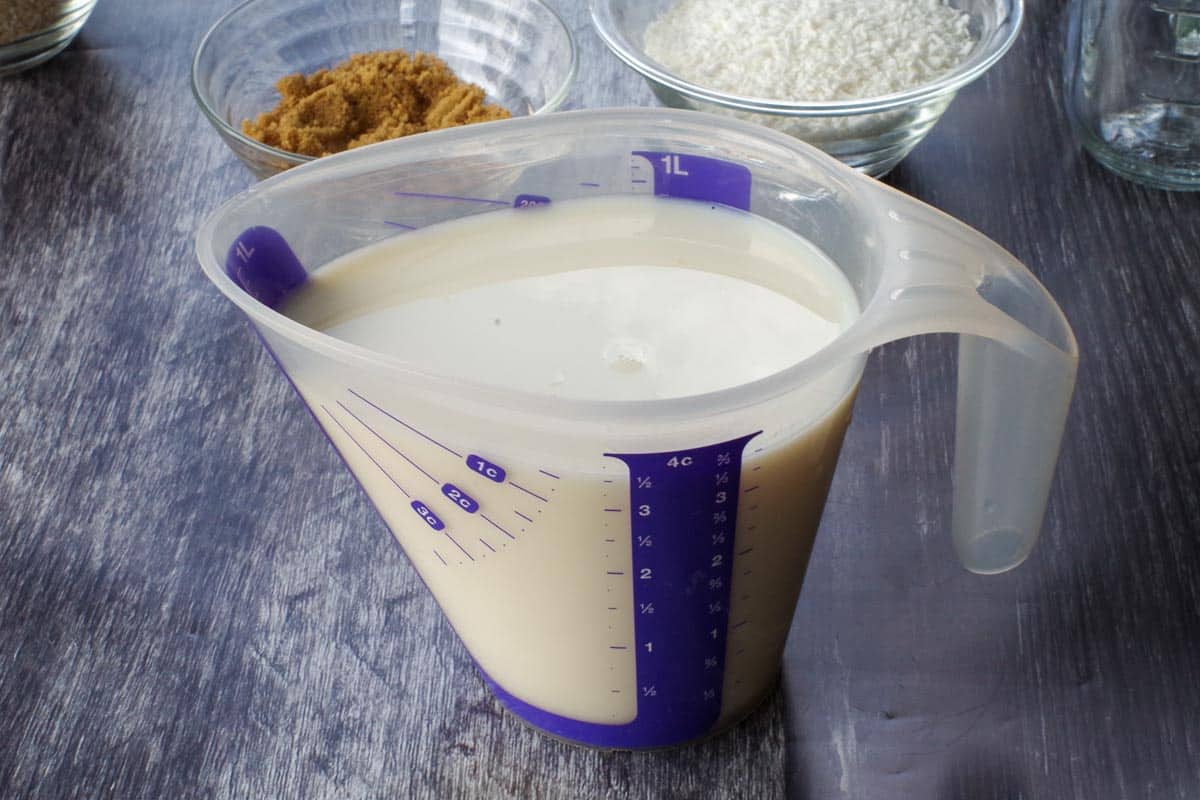 milk mixed with orange and vanilla extract in a plastic 4 cup measuring cup
