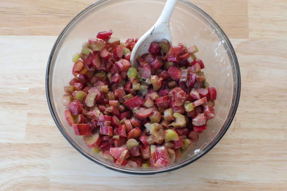 rhubarb filling ingredients in a large glass bowl with a silicone spoon