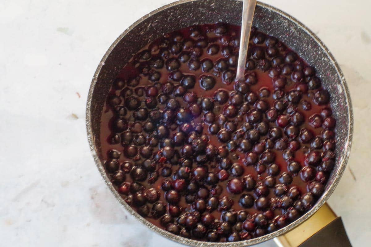 berries cooking over medium heat in a saucepan