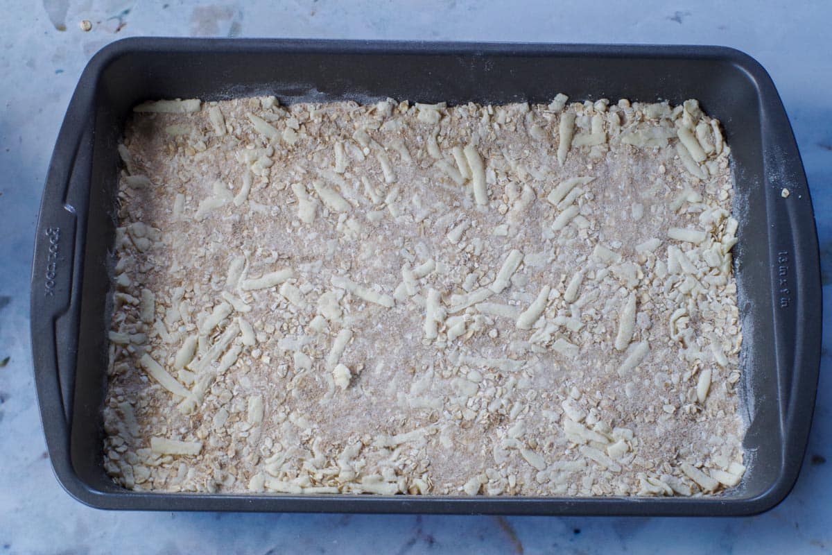 (half the mixture) base spread onto the bottom of the prepared 9x13 pan