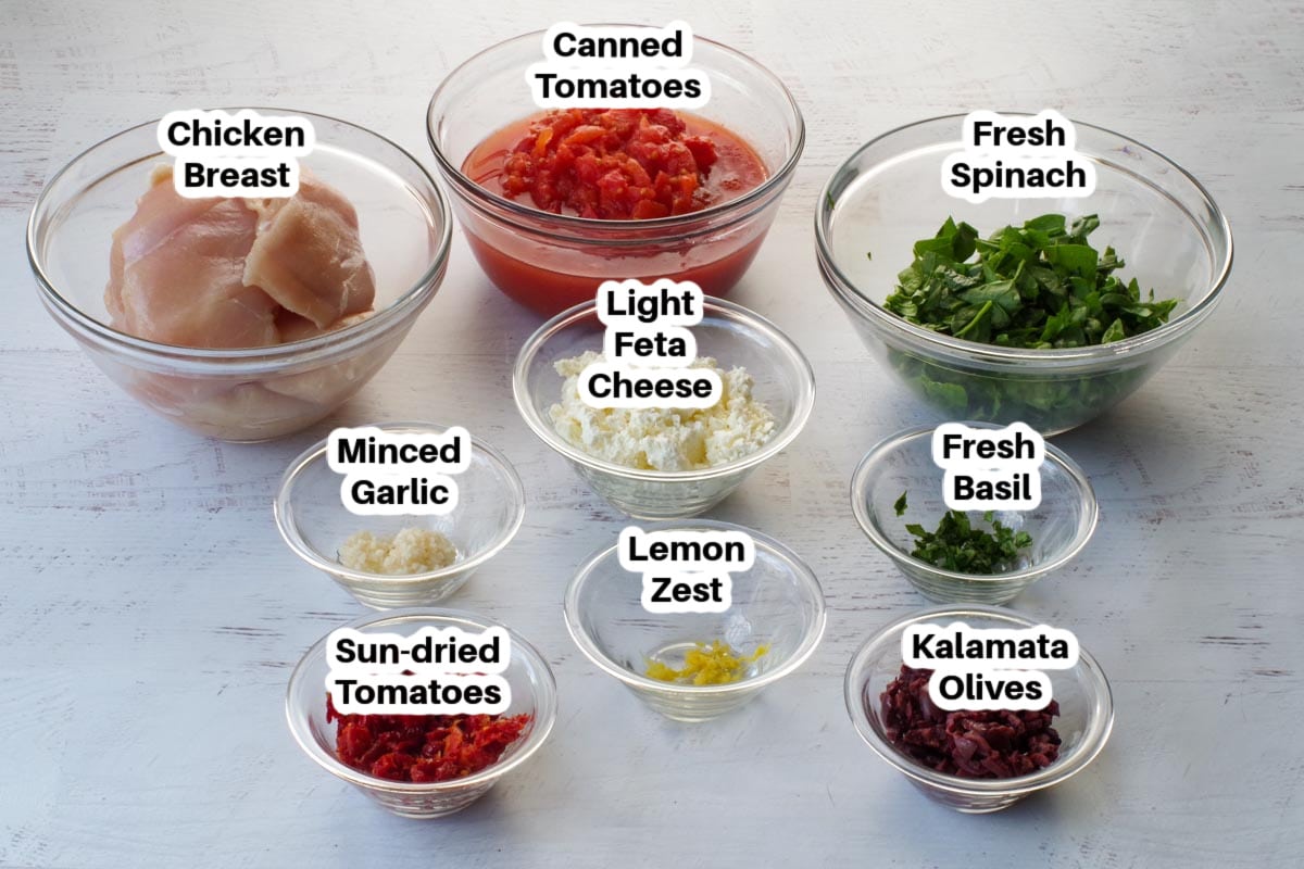 slow cooker mediterranean stuffed chicken breast ingredients in glass bowls, labelled