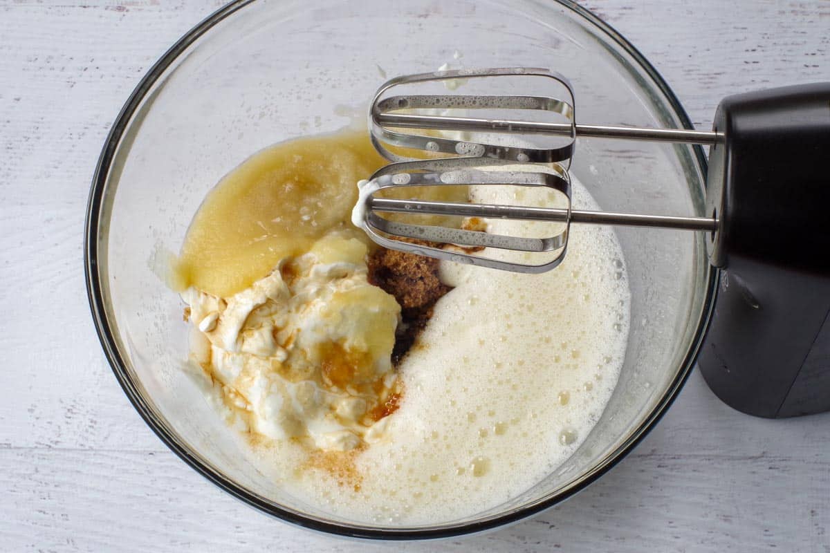 yogurt, apple sauce, vanilla and brown sugar with eggs in large glass bowl