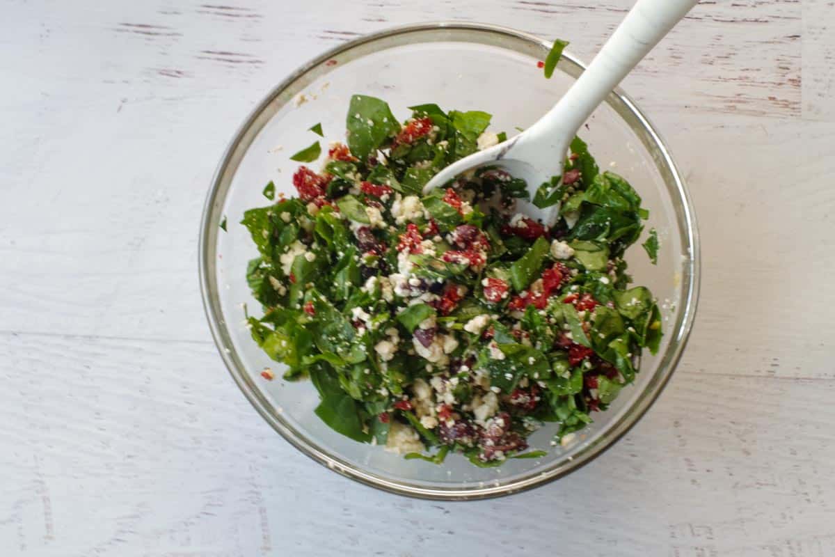 filling ingredients mixed well in a glass bowl with spoon