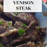 cooked venison steak in a skillet with a spatula turner