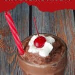 Weight Watchers Chocolate Frosty in a tall soda glass, with a straw and a dollop of whipped cream and a cherry on top