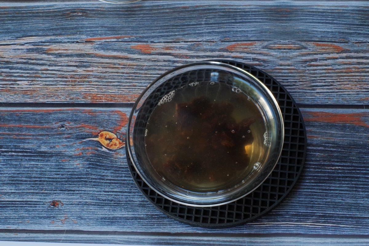 dried cherries in hot water in small glass bowl