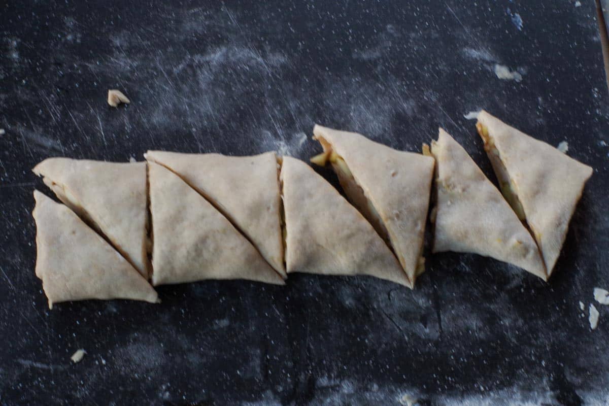 apple cinnamon scones cut on cutting board