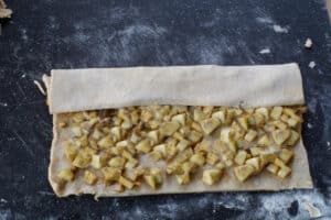 dough folded over first ⅓ of apple mixture