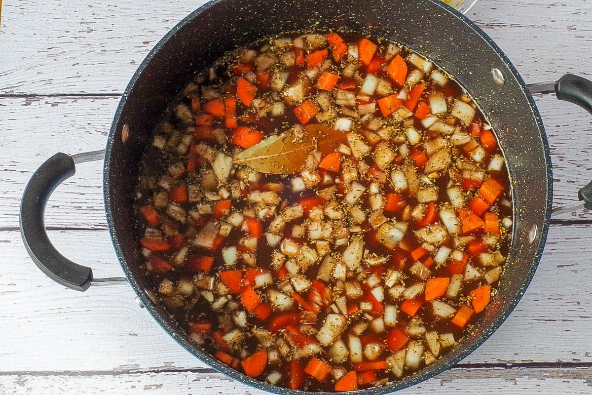 All ingredients for soup (except macaroni, parmesan cheese and parsley) in large pot