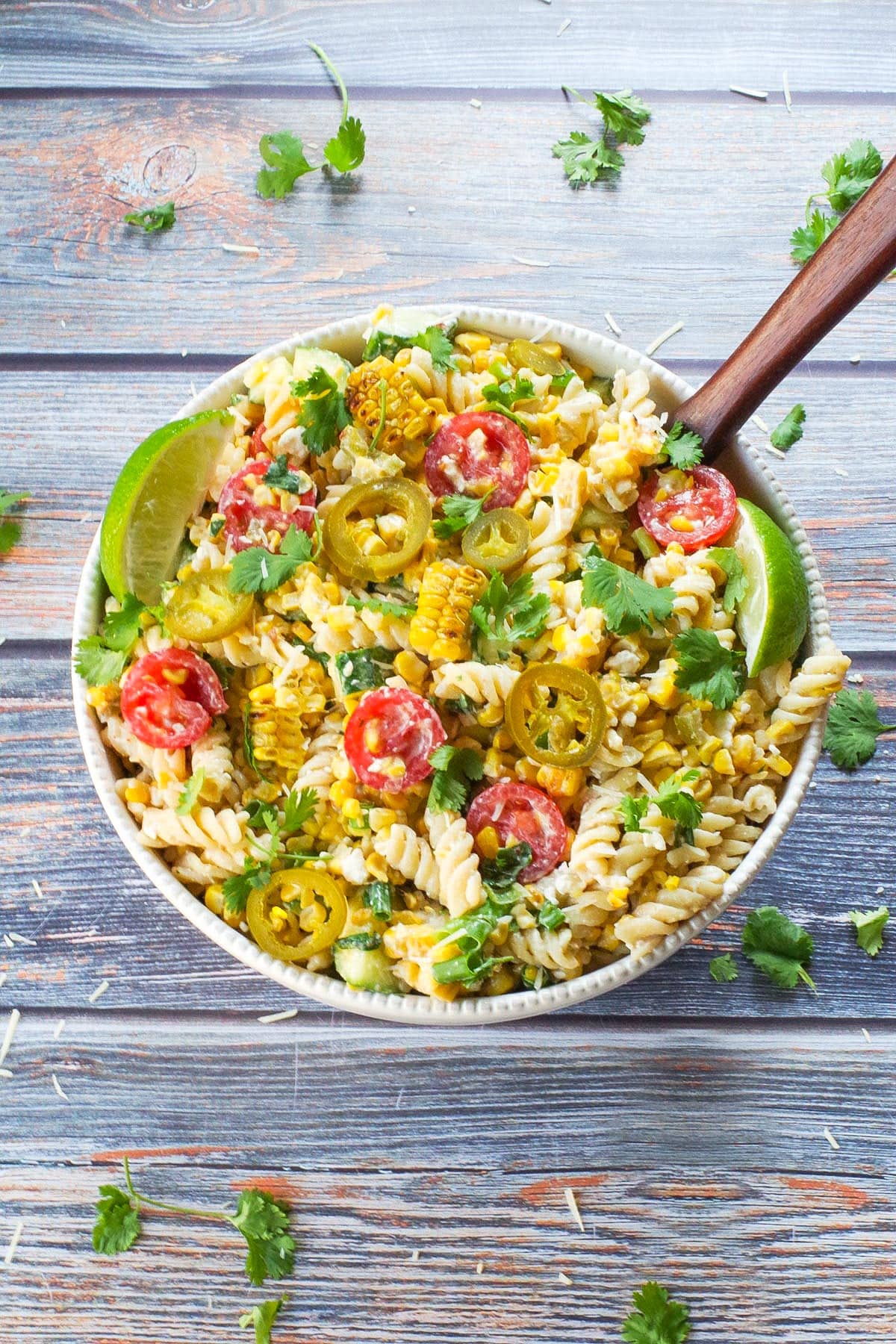 Grilled Mexican Street Corn Pasta Salad in a white bowl from the top view