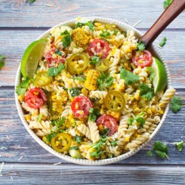 Grilled Mexican Street Corn Pasta Salad in a white bowl from the top view