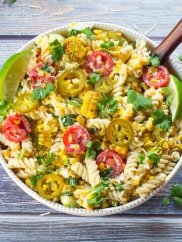 Grilled Mexican Street Corn Pasta Salad in a white bowl from the top view