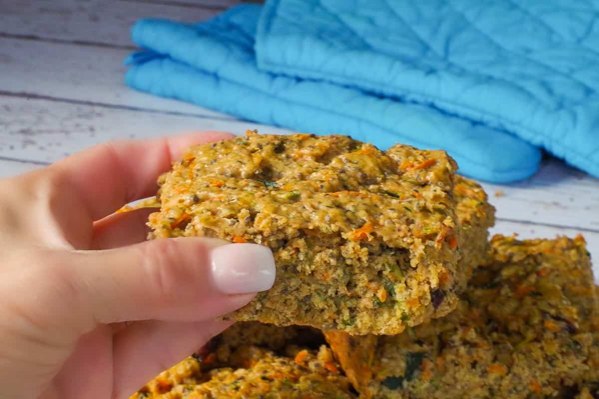 Zucchini bar being held up by a hand