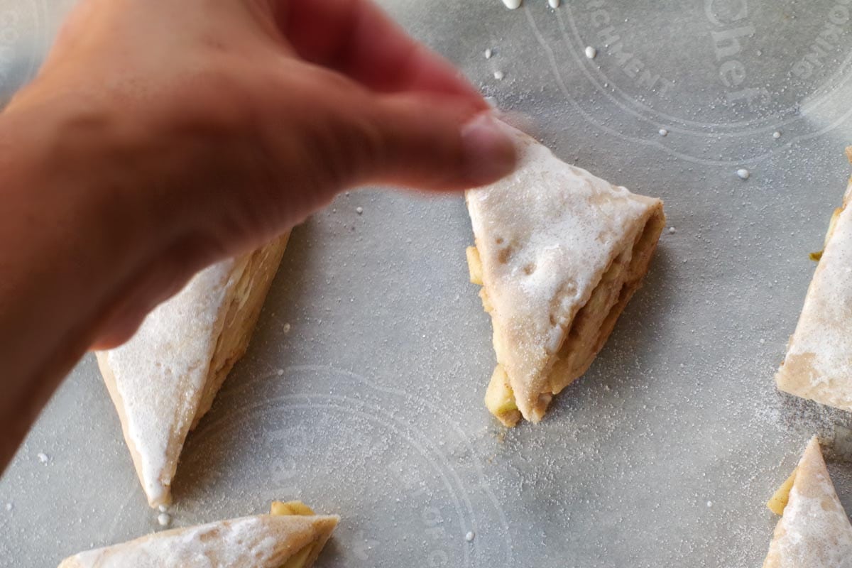 scones being sprinkled with sugar