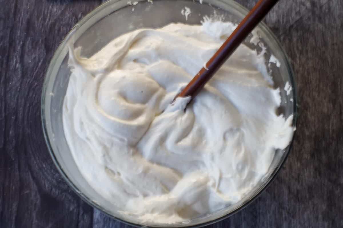 melted marshmallows in glass bowl with wooden spoon